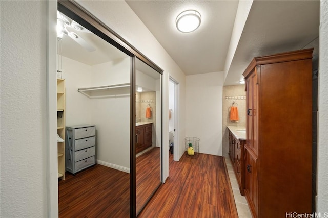 bathroom with ceiling fan, vanity, and hardwood / wood-style flooring