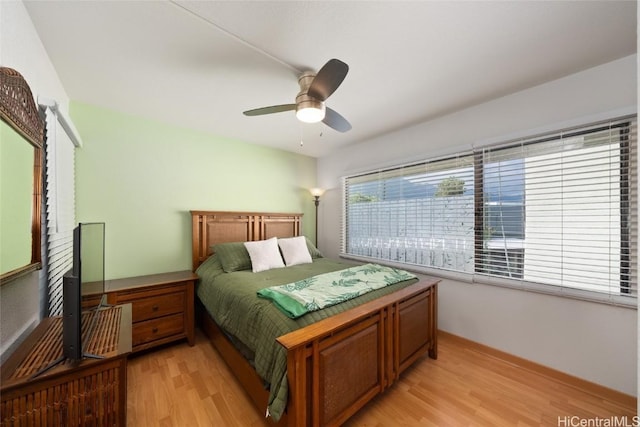 bedroom with ceiling fan and light hardwood / wood-style floors