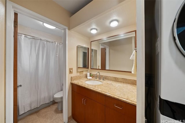 bathroom with washer / clothes dryer, tile patterned flooring, vanity, and toilet