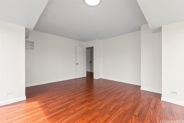 empty room with hardwood / wood-style flooring