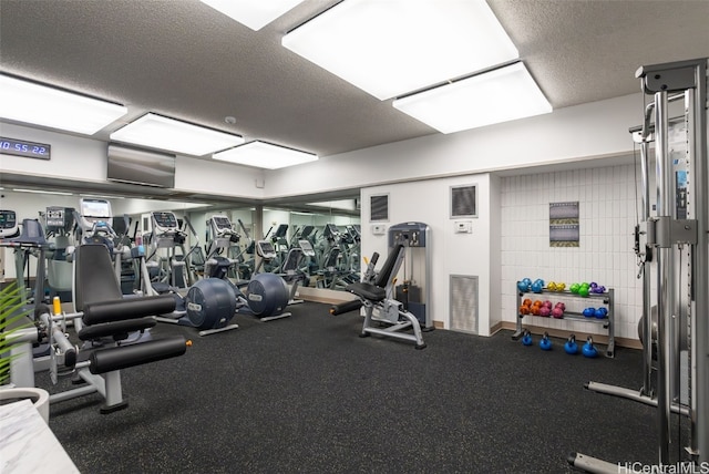 exercise room featuring a textured ceiling