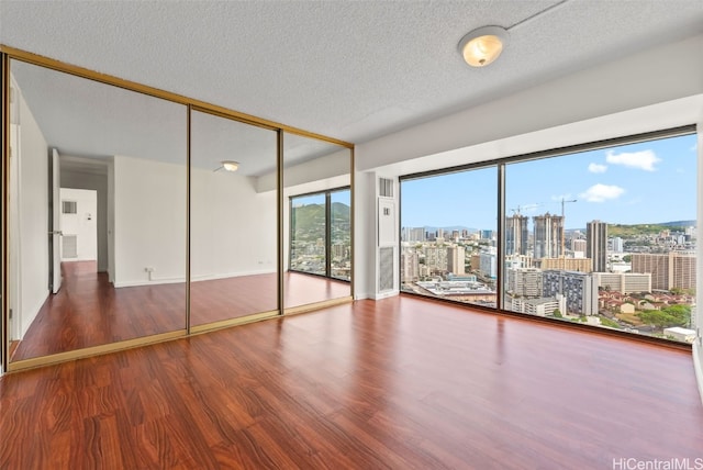 interior space featuring hardwood / wood-style flooring and a textured ceiling