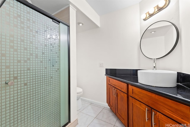 bathroom featuring a shower with door, vanity, tile patterned floors, and toilet