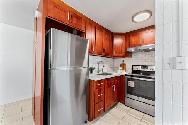 kitchen with sink, backsplash, light tile patterned floors, and stainless steel appliances