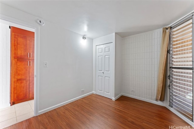 unfurnished room with light wood-type flooring