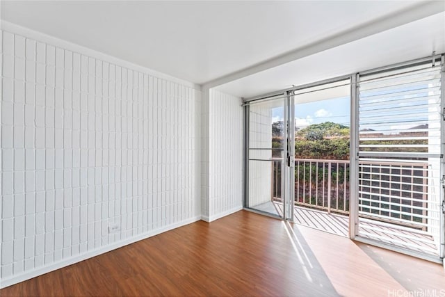 spare room with hardwood / wood-style flooring