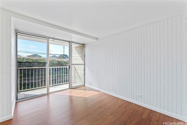 spare room with hardwood / wood-style flooring