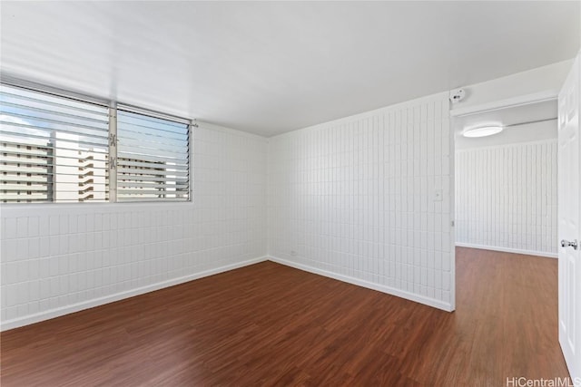 empty room with hardwood / wood-style flooring