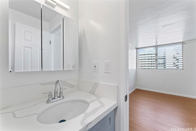 bathroom featuring hardwood / wood-style flooring and vanity