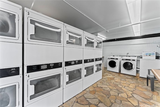 washroom featuring independent washer and dryer and stacked washer and dryer