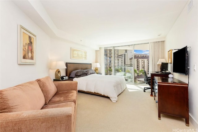 carpeted bedroom with access to exterior and floor to ceiling windows