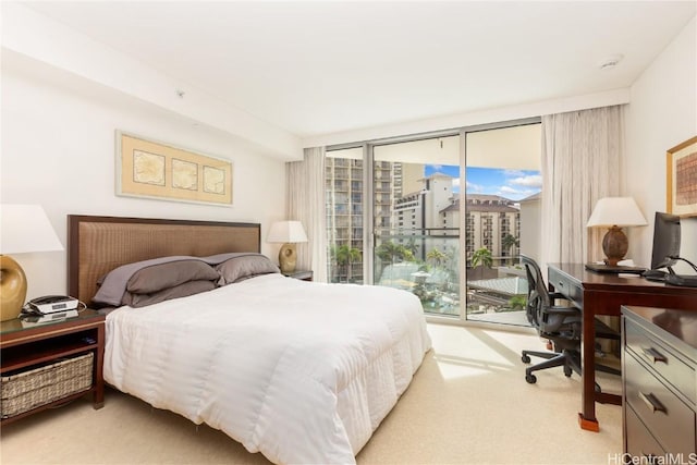 carpeted bedroom with floor to ceiling windows, access to exterior, and multiple windows