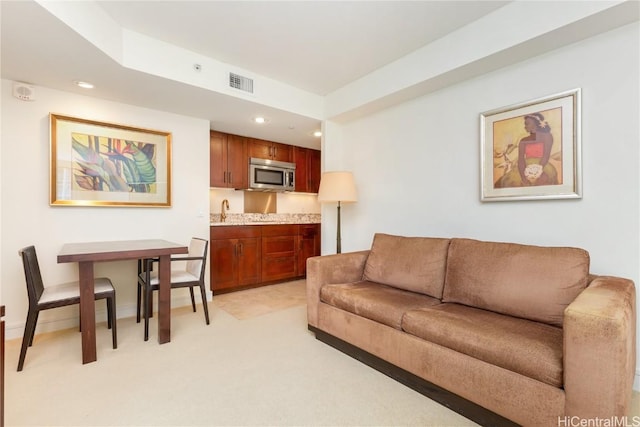 living room featuring sink and light carpet