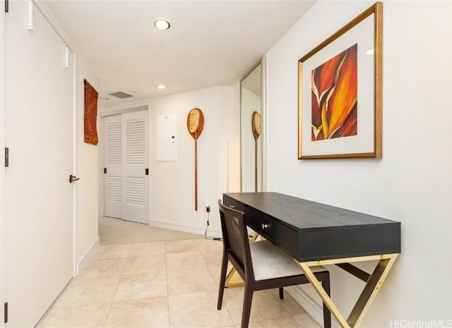 hall with light tile patterned floors