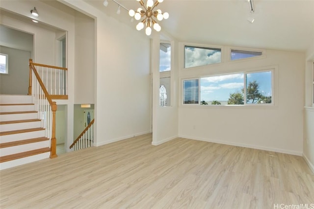 interior space with light hardwood / wood-style flooring, a chandelier, and vaulted ceiling