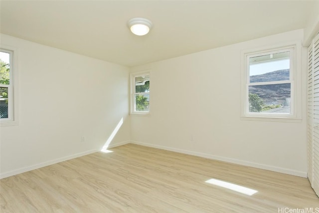 unfurnished room with light hardwood / wood-style flooring