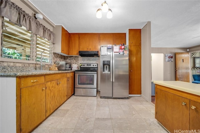 kitchen featuring sink, stainless steel appliances, and range hood