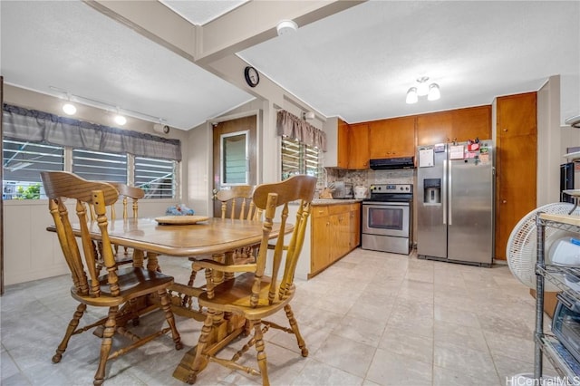 kitchen featuring decorative backsplash, a healthy amount of sunlight, stainless steel appliances, and range hood