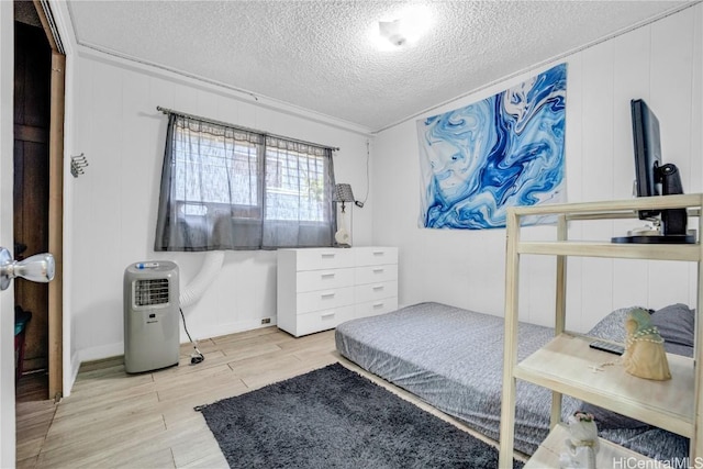 bedroom featuring a textured ceiling and ornamental molding