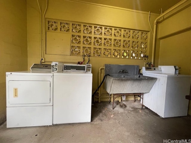 laundry room with washing machine and dryer and sink