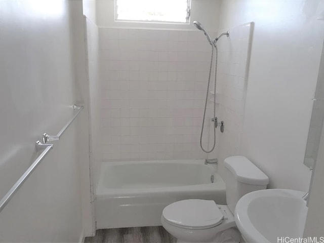 full bathroom with sink, toilet, tiled shower / bath combo, and hardwood / wood-style flooring