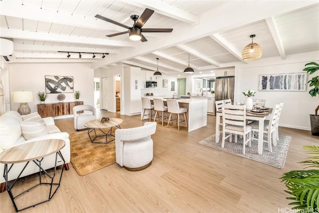 living room with beamed ceiling, light wood-type flooring, a wall mounted air conditioner, and ceiling fan