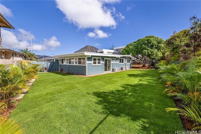 rear view of house with a yard