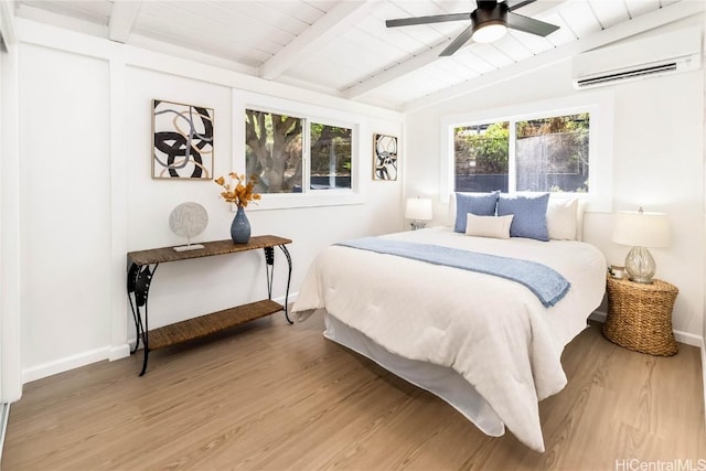 bedroom featuring a wall mounted air conditioner, multiple windows, hardwood / wood-style flooring, and ceiling fan