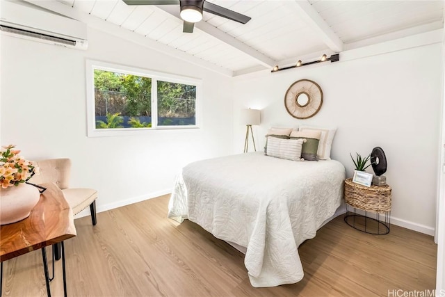 bedroom with lofted ceiling with beams, hardwood / wood-style flooring, a wall unit AC, and ceiling fan