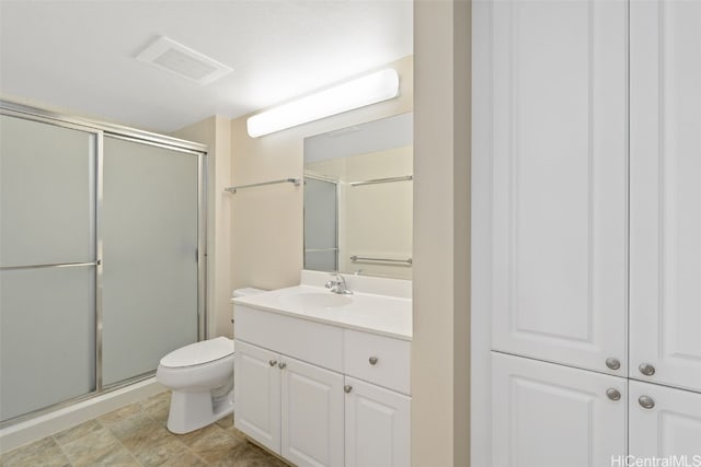 bathroom featuring vanity, toilet, and walk in shower