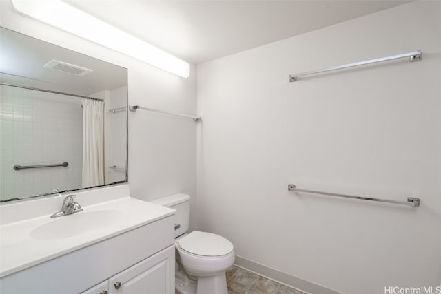 bathroom featuring vanity, toilet, and curtained shower