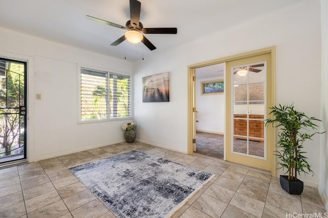 tiled entryway featuring ceiling fan