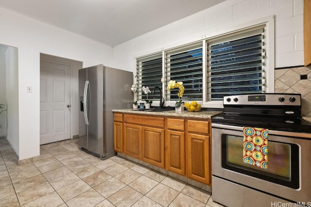 kitchen featuring tasteful backsplash, sink, and appliances with stainless steel finishes