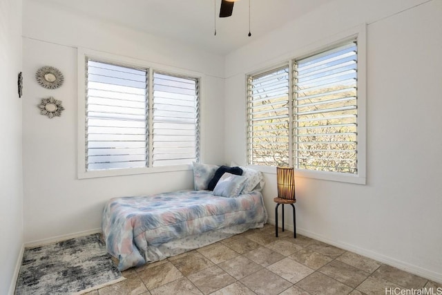 bedroom with multiple windows and ceiling fan