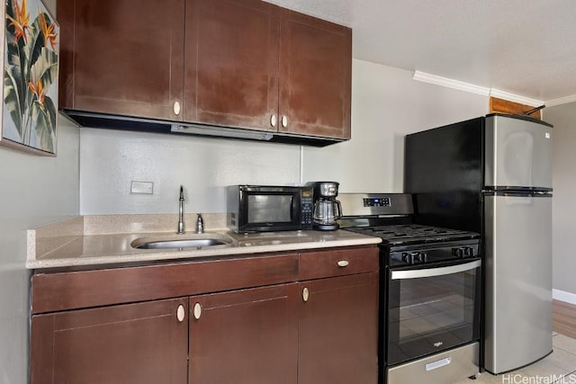 kitchen with ornamental molding, stainless steel appliances, dark brown cabinets, and sink