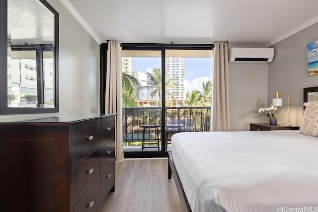 bedroom featuring an AC wall unit, light hardwood / wood-style flooring, a wall of windows, ornamental molding, and access to exterior