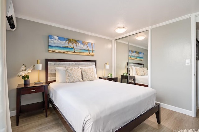 bedroom with hardwood / wood-style floors, a closet, and crown molding