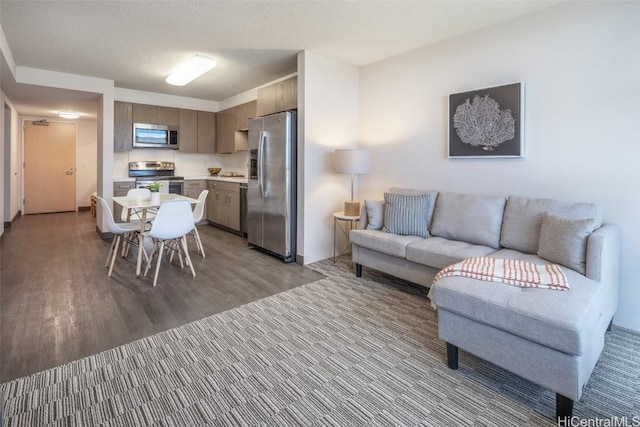 living room featuring a textured ceiling and light hardwood / wood-style flooring