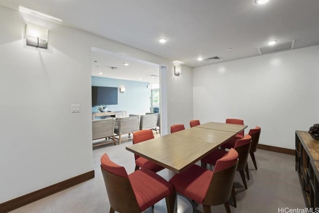 dining room featuring recessed lighting, baseboards, visible vents, and light carpet