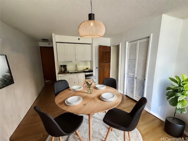 dining space with dark hardwood / wood-style flooring