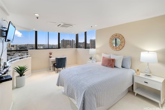 carpeted bedroom featuring a view of city, visible vents, and recessed lighting