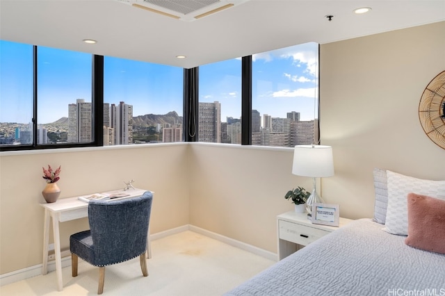 carpeted bedroom featuring visible vents, baseboards, a city view, and recessed lighting