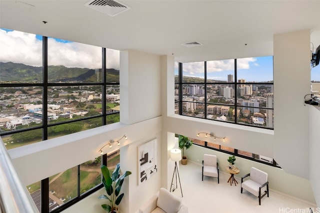 details featuring carpet floors, a view of city, visible vents, and a mountain view