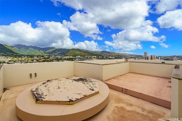 view of patio / terrace with a mountain view and a balcony