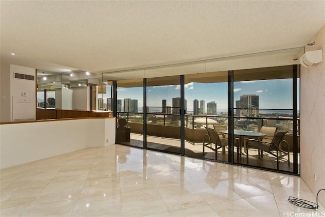 empty room with a wall of windows and a textured ceiling