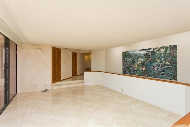 unfurnished room featuring a textured ceiling