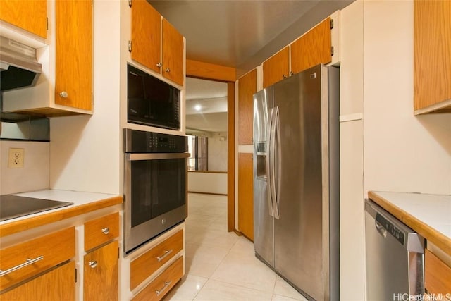 kitchen with light tile patterned floors and black appliances