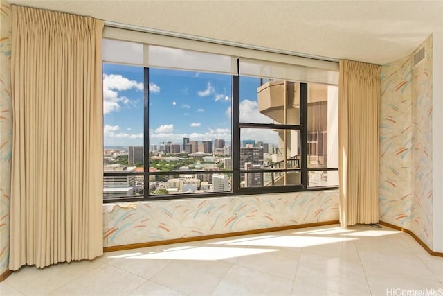 tiled empty room with floor to ceiling windows