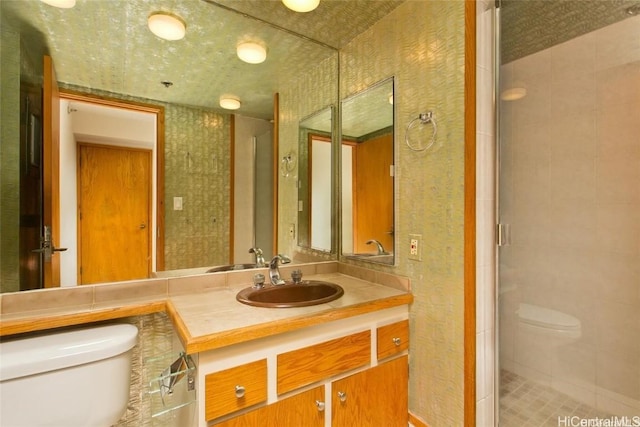 bathroom with vanity, toilet, and an enclosed shower