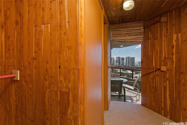 corridor featuring carpet floors and wooden ceiling